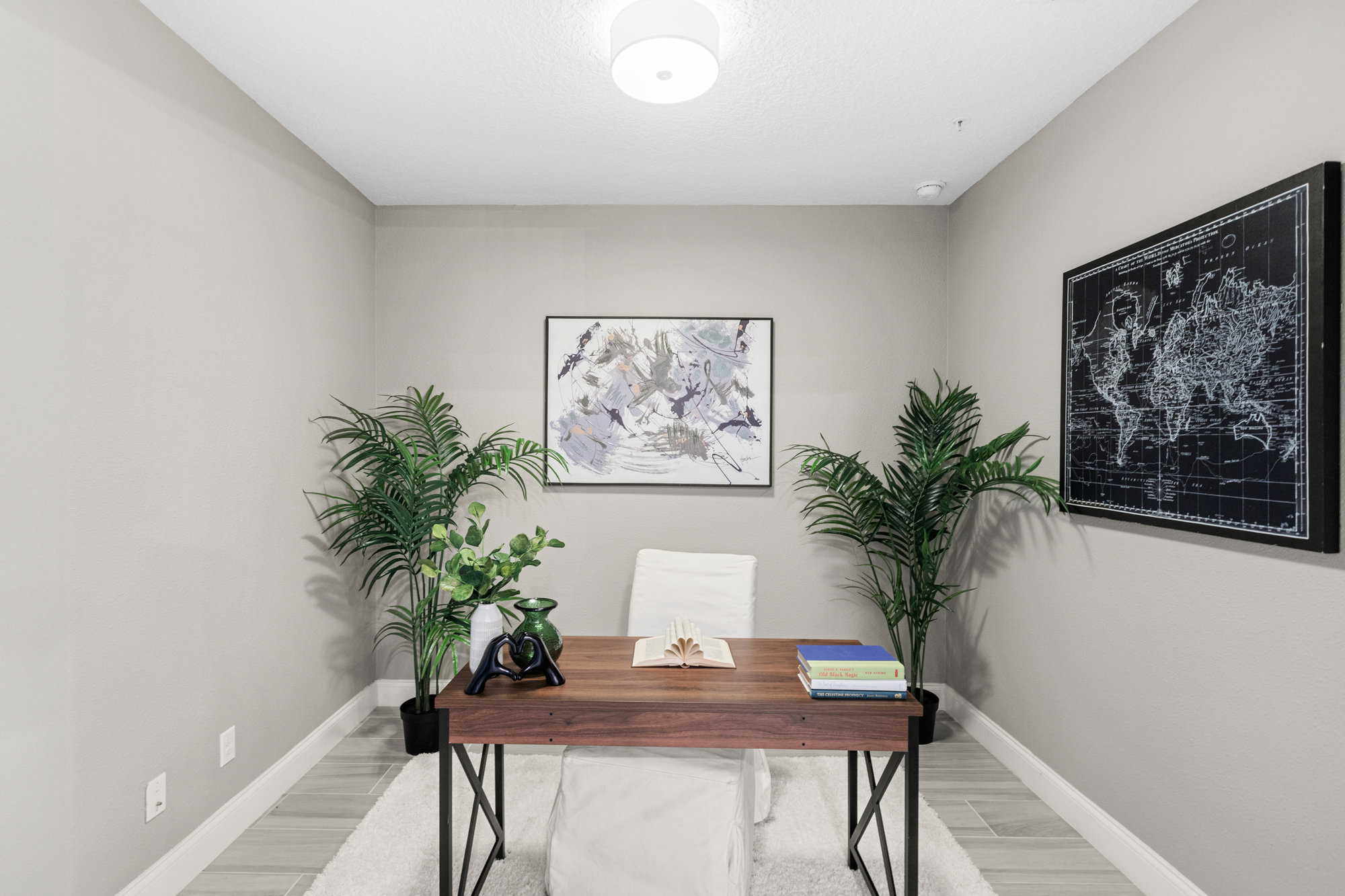 office with brown walls and wood plank floors